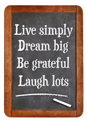 small chalkboard reads live simply dream big be grateful laugh lots with brown wooden frame 