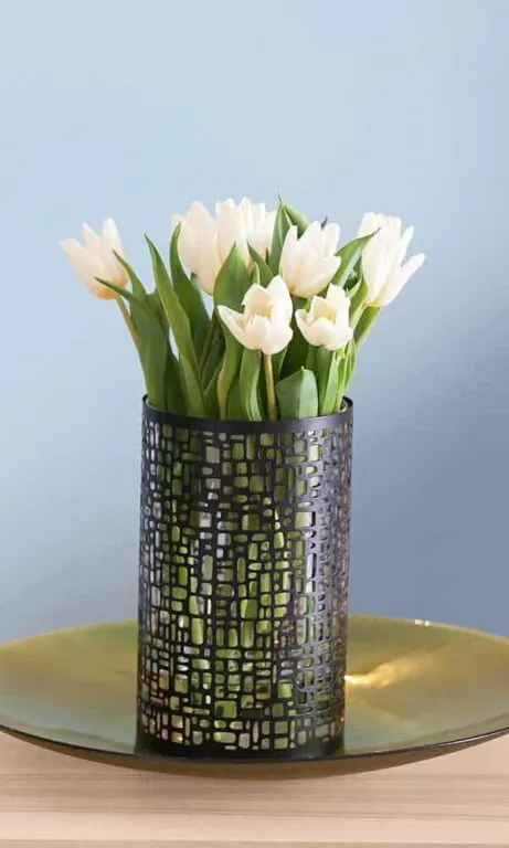 A vase containing a bouquet of white tulips